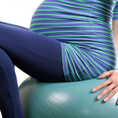 Pregnant woman sat on swiss ball