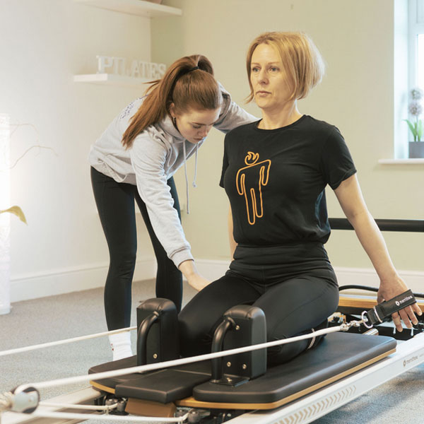 Reformer instructor with client